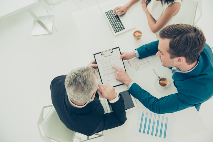 two businessmen reviewing a contract