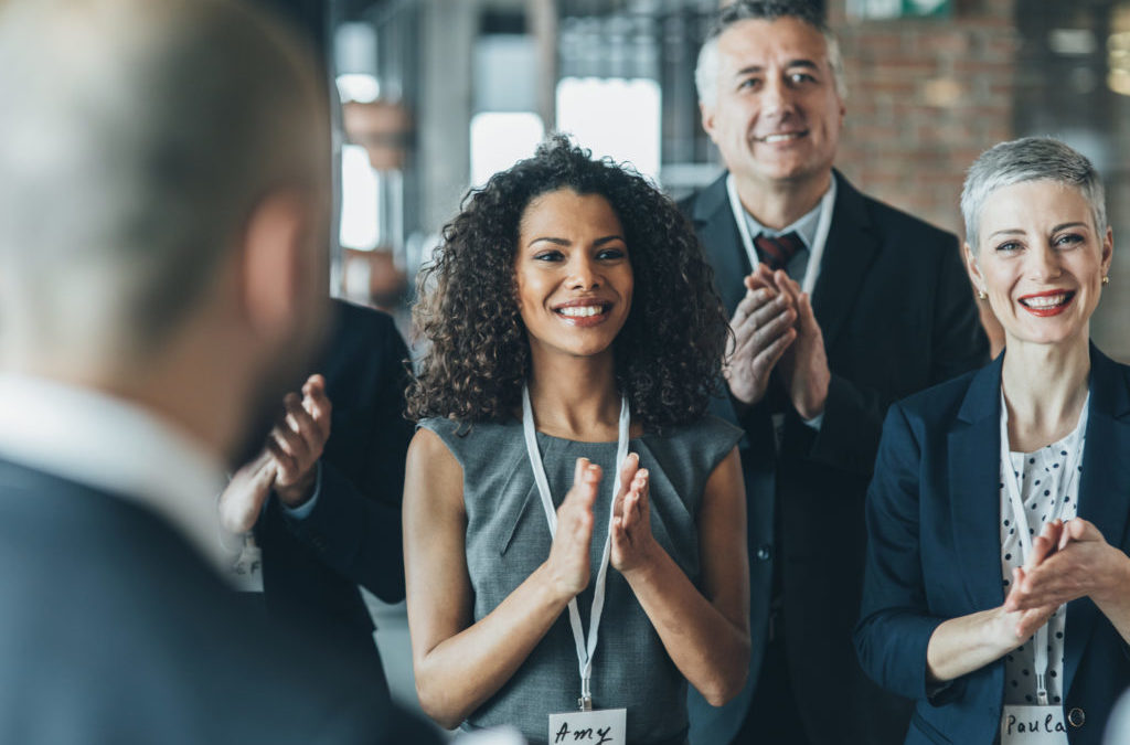 a group of businesspersons applauding