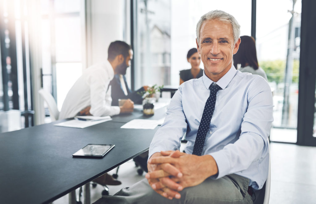 a businessman in a conference room with his colleagues